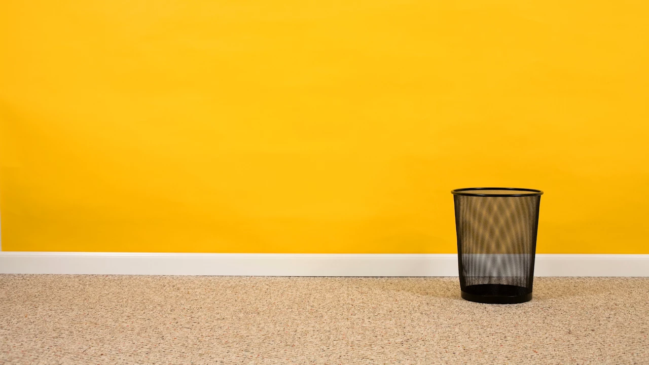 Empty black mesh waste basket.